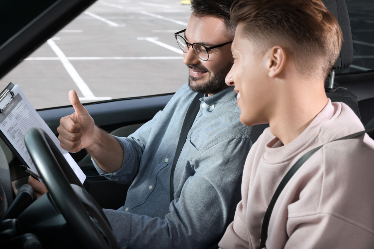 men taking driving school in car