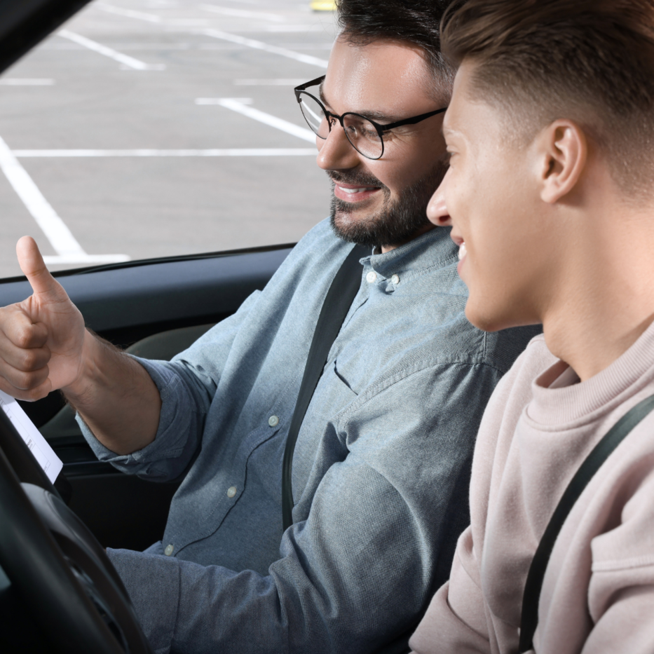men taking driving school in car